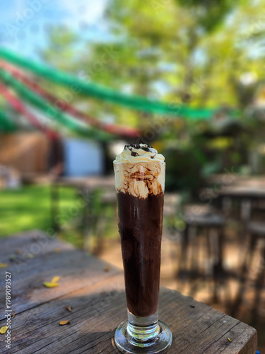 Iced Chocolate Drink with Whipped Cream on Wooden Table