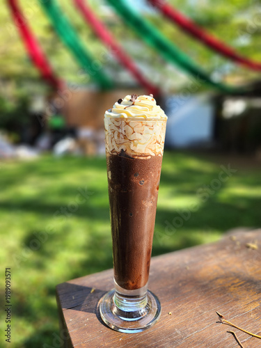 Iced Chocolate Drink with Whipped Cream on Wooden Table