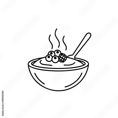 Hot breakfast polenta topped with berries in bowl with spoon  