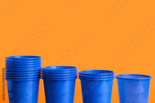 Blue plastic cups on orange...