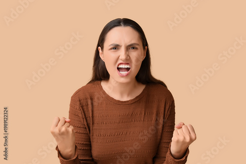 Young woman screaming on be...