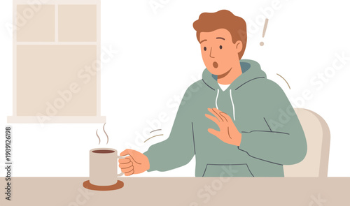 Man reacts to hot coffee at indoor table by window