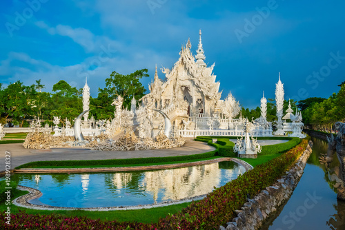 Wat Rong Khun The White Abstract Temple and pond with fish, in Chiang Rai, Thailand. Popular and famous in vacation for tourist.