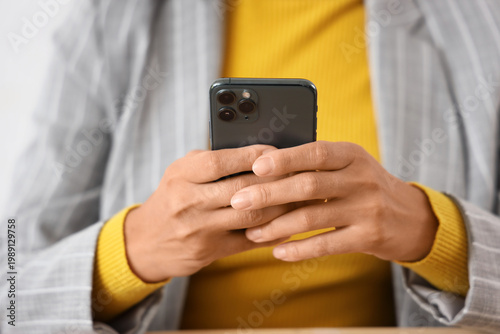 Young businesswoman using m...