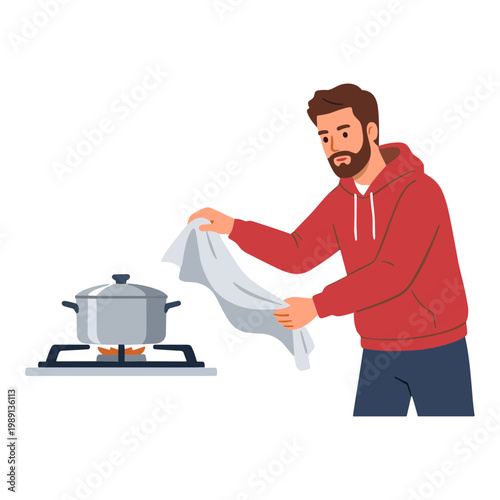 Man cooking on stove with pot and using towel