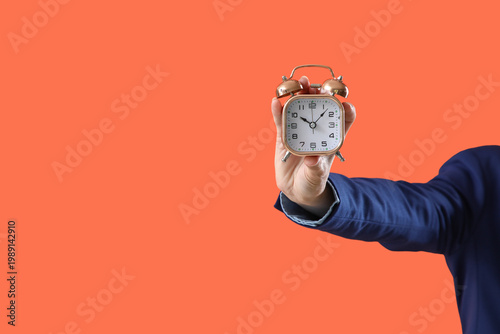 Female hand with alarm cloc...