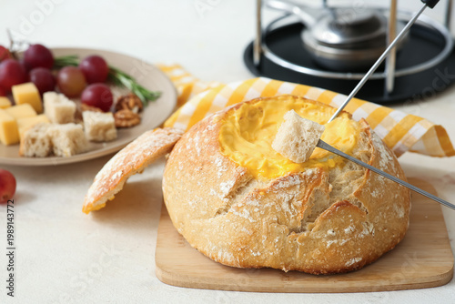Fondue pot with melted chee...