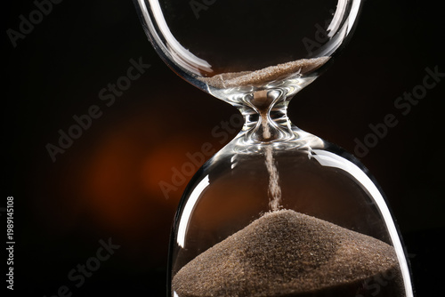 Crystal hourglass on dark b...