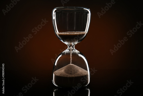 Crystal hourglass on dark b...