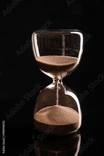 Crystal hourglass on black ...