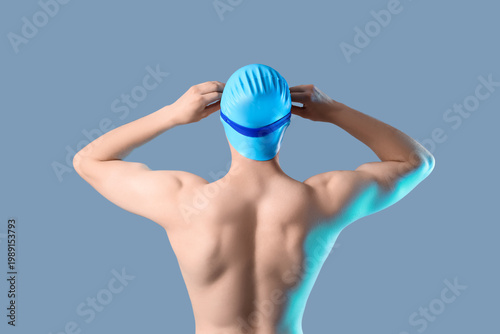 Male swimmer on color backg...