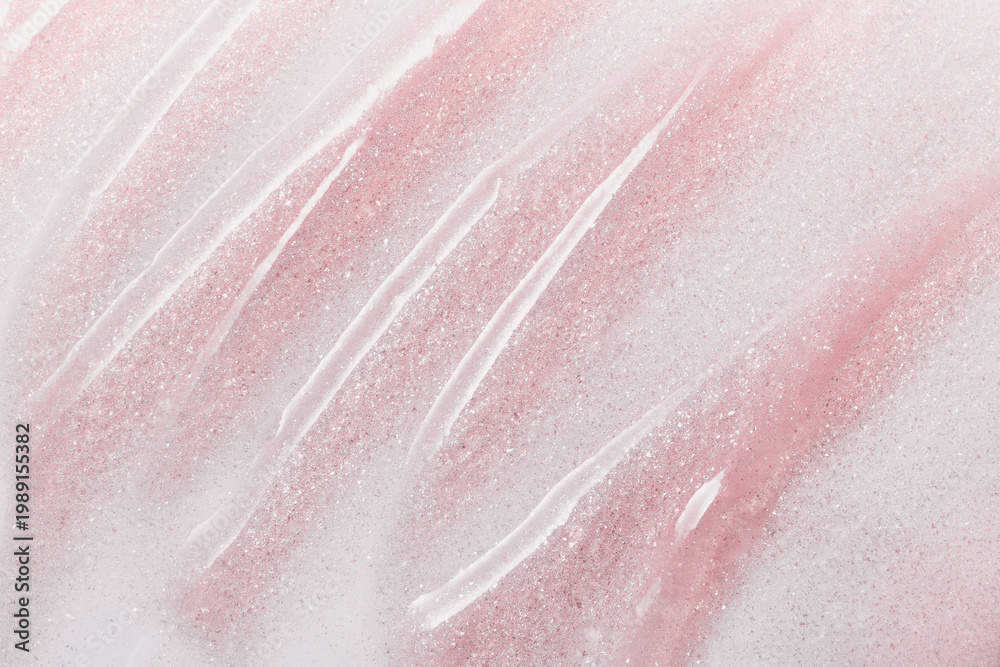Fototapeta premium Pink glitter background with cosmetic streaks creating an abstract texture