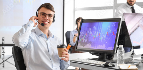 Male trader with headset an...
