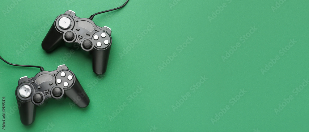 Naklejka premium Modern game pads on color background