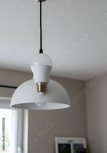 White pendant lamp with modern design in a neutral-toned room. Hanging light fixture with a clean aesthetic.