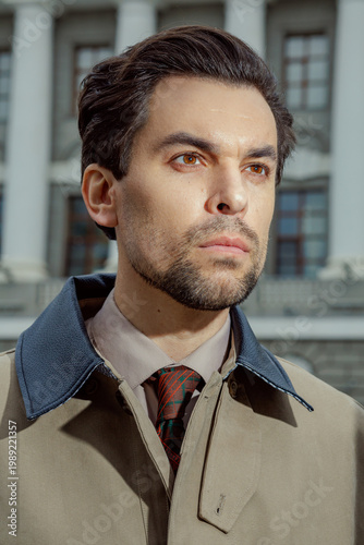 Obraz na płótnie Close-up portrait of a charismatic mid-adult businessman outdoors