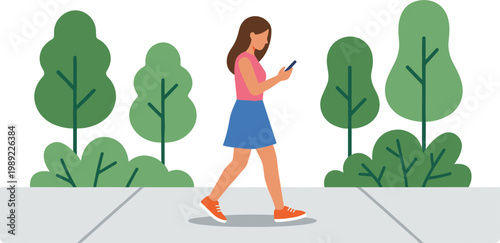 Woman walks down sidewalk looking at phone near green trees and bushes.