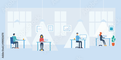 People working on computers in a bright open plan office space