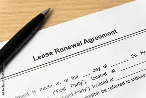 Legal document Lease Renewal Agreement on paper close up with pen