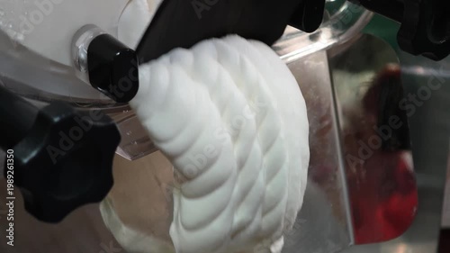 ice cream coming out of the ice cream maker. freshly made homemade ice cream