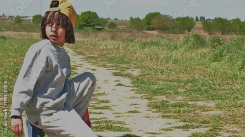 Curious boy exploring a path in a beautiful green field
