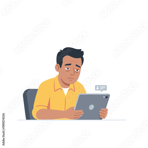 Man sitting indoors looking concerned while holding a tablet