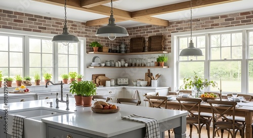 Bright kitchen with brick wall, wooden beams, island, dining table, and many potted herbs on the windowsill