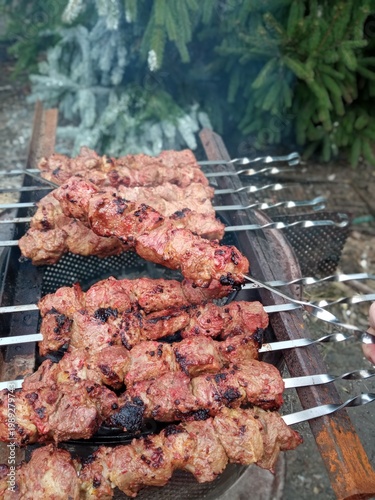 Shish kebab on skewers is cooked in the fresh air.