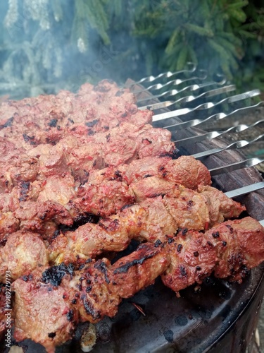 Shish kebab on skewers is cooked in the fresh air.