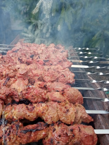 Shish kebab on skewers is cooked in the fresh air.