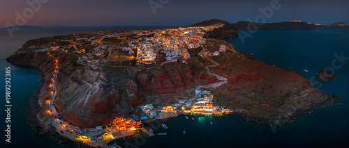 Aerial view of Oia town and caldera on Santorini island ay night, Greece. 
