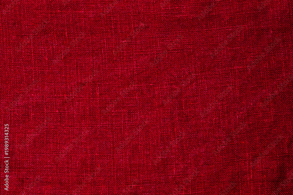 Fototapeta premium Bright red fabric showing texture and weave in a simple design suitable for various uses