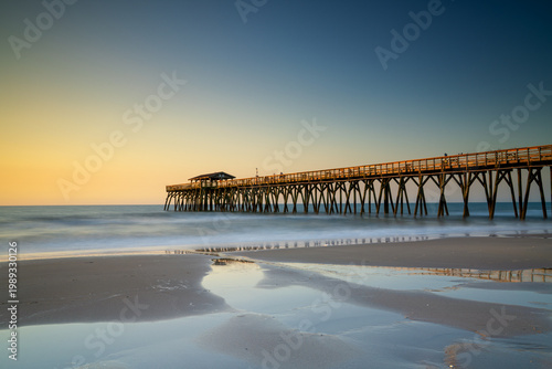 view of the historic Myrtle Beach State Park wooden pier at sunrise