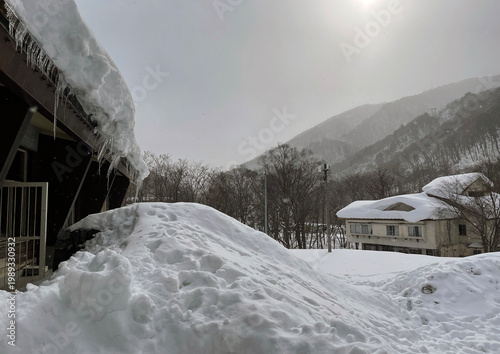 Snow covered buildings with icicles in Northern Japan