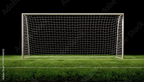 A brightly lit soccer goal stands prominently on a lush green field against a stark black background.