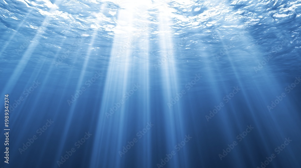Obraz premium Sunbeams filtering through deep blue ocean water