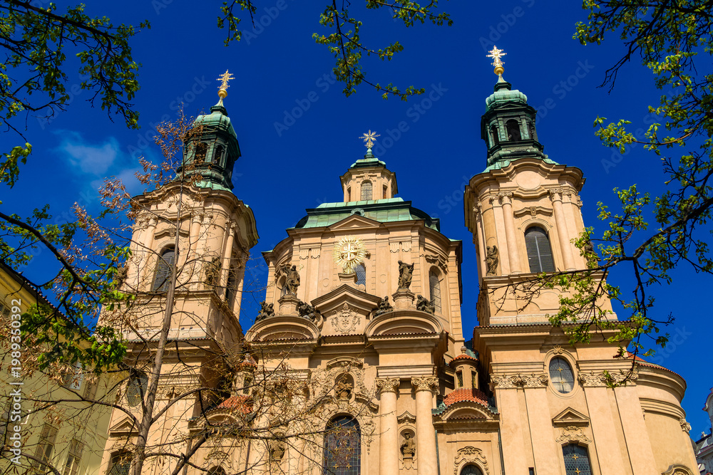 Obraz premium St Nicholas Church Prague in spring with blue sky
