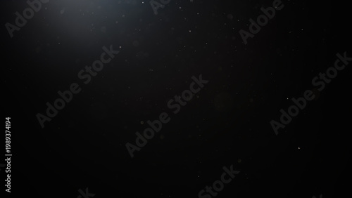 dust particles floating mid air over dark background