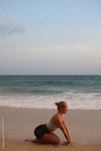 Beach yoga photos. Serene beach scene with balanced woman exuding strength and mental concentration