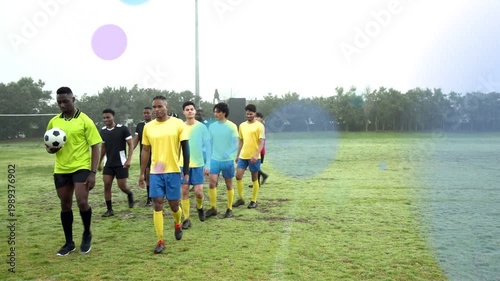 Soccer players warming up across pitch led by green leader carrying ball, colored circles expanding