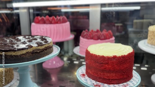 Assorted cakes in bakery display, dessert and pastry concept, confectionery showcase, sweet treats, cafe interior, colorful dessert selection