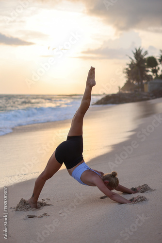 Beach sunset yoga. Serene sunset yoga session on beach demonstrating strength and mindful breathing