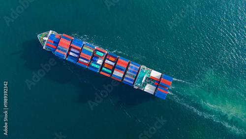 Tableau sur toile large cargo container ship fully loaded with colorful containers sailing through the deep blue ocean