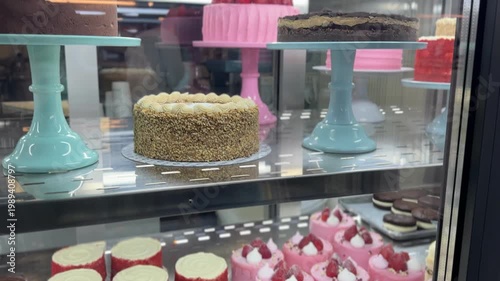 Assorted cakes in bakery display case, dessert and pastry concept, confectionery showcase, sweet treats, cafe interior, close up food selection