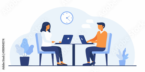 Two professionals having a meeting and working on laptops at a table