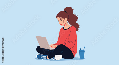 Young woman sitting cross-legged on the floor and working on her laptop with a coffee cup nearby in a relaxed indoor setting.