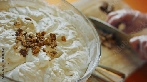 Knife chopping chocolate for mixing into prepared ice cream