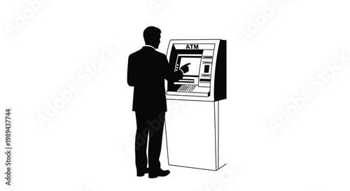 A silhouette of a man using an atm machine in a public space