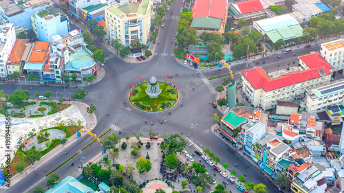 Tablou pe pânză Aerial view of a busy urban roundabout in Nha Trang city, Vietnam, where roads converge around a landscaped traffic circle