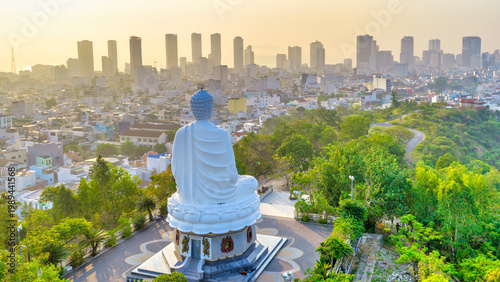 Vászonkép A majestic view of the giant white Buddha statue at Long Son Pagoda, Nha Trang, Vietnam peacefully seated atop a hill overlooking the city